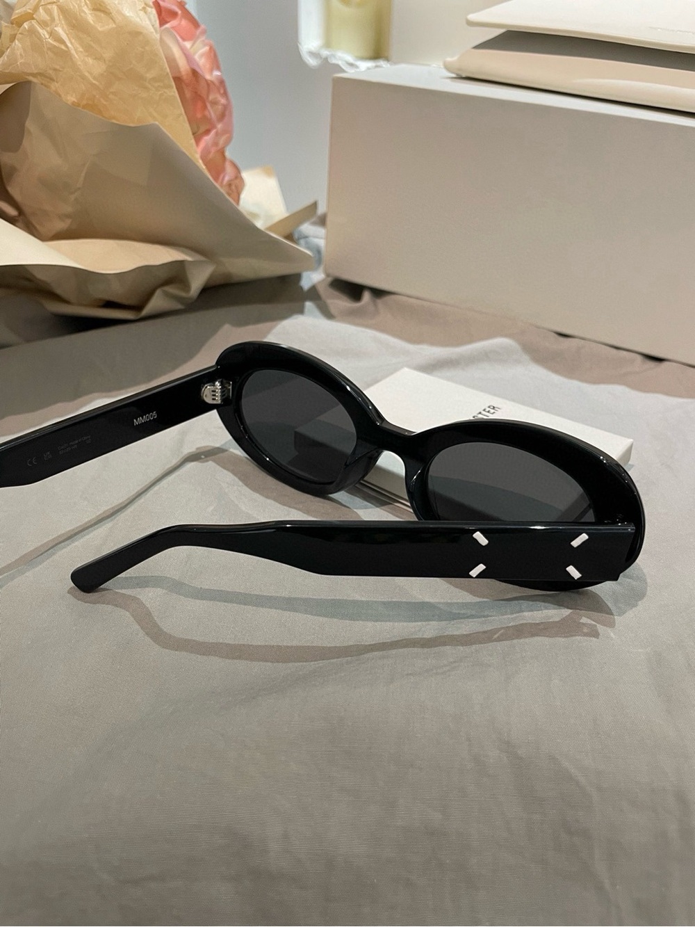 GENTLE MONSTER Black Oval Sunglasses with White Temple Accents